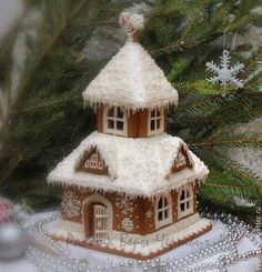 a gingerbread house with snow on the roof