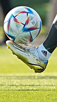 a close up of a person's foot kicking a soccer ball