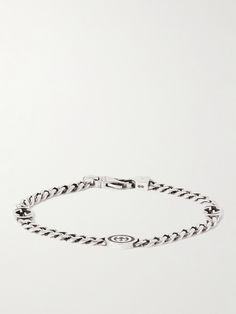 Gucci incorporates its signature interlocking 'GG' emblems into the curb chain of this bracelet, one is enamelled for sleek contrast. It's been made in Italy from sterling silver and slightly burnished for a vintage effect. Luxury White Gold Chain Bracelet With Curb Chain, Luxury Silver Bracelets With Curb Chain, Luxury Silver Bracelet With Curb Chain, Luxury Engraved Link Chain Bracelet, Luxury Silver Curb Chain Bracelet, Luxury Engraved Metal Chain Bracelet, Luxury Curb Chain Bracelet, Designer Metal Jewelry, Luxury Engraved Oval Link Chain Bracelet