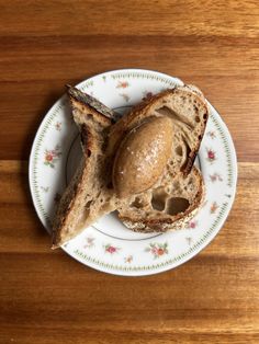 a piece of bread with peanut butter on it sitting on top of a white plate