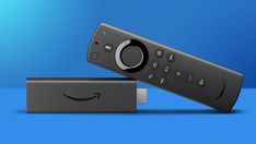 an amazon fire tv remote sitting on top of a blue surface with the amazon logo above it