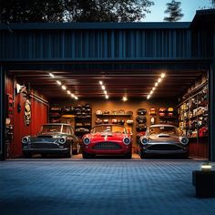 two cars are parked in the garage with their lights on