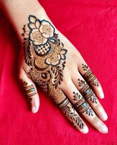 a woman's hand is decorated with hennap and intricate designs on it