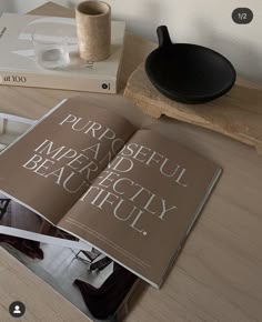 an open book sitting on top of a wooden table