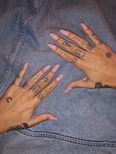 two hands with tattoos on their fingers