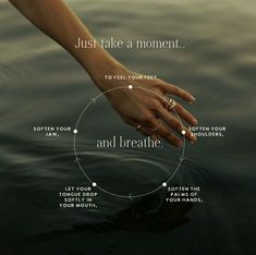 a woman's hand reaching out to the water with her ring on it that says, just take a moment and breathe