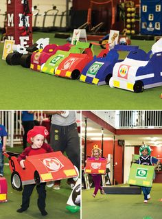 children in costumes are playing with toy cars at the indoor play area, and another child is holding a cardboard race car