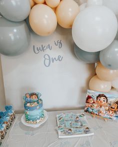 there is a cake and balloons on the table