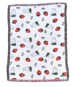 a blanket with rabbits and strawberries on it