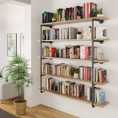 a bookshelf filled with lots of books next to a couch and potted plant