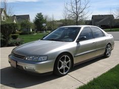 a silver car is parked in the driveway