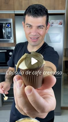 a man holding a cupcake in his hand with the words cappula de afe cremoso on it