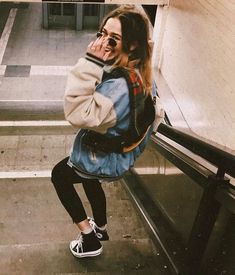 a woman sitting on an escalator talking on her cell phone