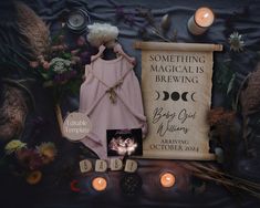 an image of a baby's birth announcement surrounded by candles and other items on a blanket