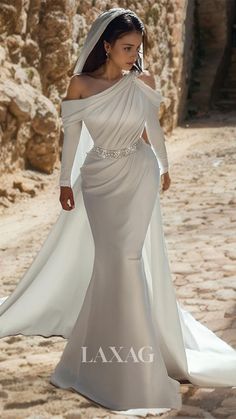 a woman in a wedding dress walking down the street