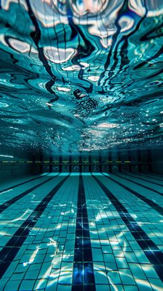 an underwater swimming pool with tiled floors and blue water