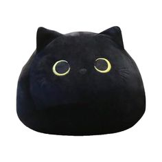 a black cat shaped pillow with yellow eyes