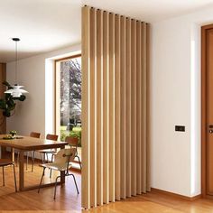 a dining room with wooden floors and sliding doors