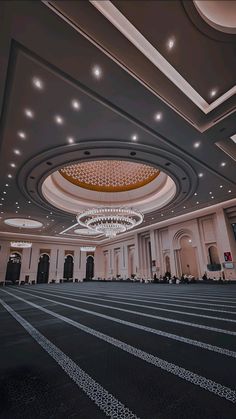 an empty ballroom with chandeliers and lights on the ceiling is pictured in this image