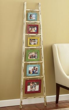 a ladder leaning against a wall with pictures on it