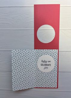 two red and white greeting cards sitting next to each other on top of a wooden table