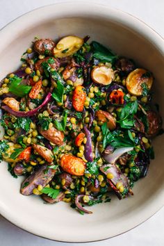 a white bowl filled with vegetables on top of a table