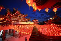 lanterns lit up in the night sky at a chinese temple