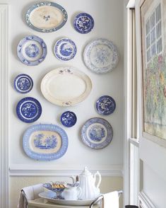 blue and white plates are hanging on the wall