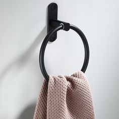 a towel hanging on a hook in a room with white walls and flooring,