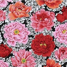 red and pink flowers are on a black and white floral print background, with an orange center in the middle