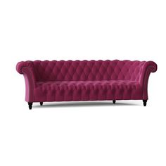 a pink couch with black legs and buttons on the back, sitting in front of a white background