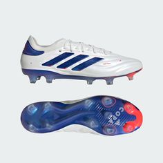 a pair of white and blue soccer shoes