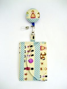 a cell phone case with a lanyard and key chain attached to the back of it