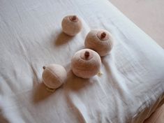 three stuffed animals are laying on top of a white bed sheet with four small ones