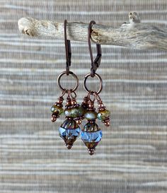 "3-dangle earrings of Czech glass and copper. The dangle hangs approximately 1-1/4\" from the bottom of the lever back earring finding. The large glass bead is 8mm x 10mm, edged and faceted. These beads are a beautiful blue. The 3mm x 5mm roundel is a marbled blue." Handmade Beaded Dangle Earrings, Glass Drop Earrings With Lever Back Ear Wires, Copper Dangle Earrings With French Hook, Copper Dangle Crystal Earrings With Ear Wire, Copper Drop Earrings With Ear Wire, Dyi Earrings, Upcycle Jewelry, Lampwork Bead Earrings, Czech Glass Jewelry