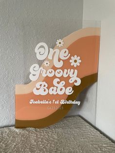 there is a sign that says one grooy bake on the side of a bed