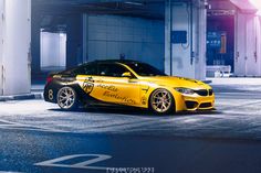 a yellow sports car parked in an empty parking garage