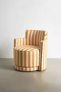 an orange and white striped chair sitting on top of a metal floor next to a wall