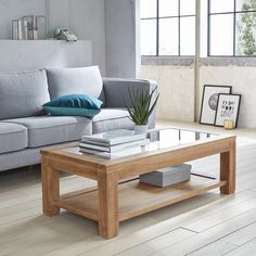 a living room with a couch, coffee table and pictures on the wall