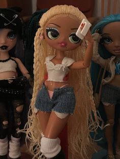 two dolls are standing next to each other and one is holding a toothbrush in her hand