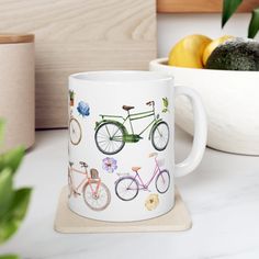 a coffee mug with bicycles painted on it