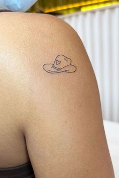 a woman with a hat tattoo on her back