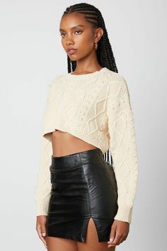 Final Sale-Get it before it's gone! Go out and enjoy the cooler weather in the Toby Natural Cable Knit Cropped Sweater! Soft cable knit, in a natural hue, shapes this cropped sweater that has a crew neckline and long sleeves with drop shoulders. Contrasting ribbed knit decorates the neckline, cuffs, and hem. The slightly wide-cut bodice ends at a cropped hem. DETAILS & CARE: Polyester. Machine wash cold. Imported. Knit Cropped Sweater, Boho Pink, Cropped Knit Sweater, Pink Boho, Crop Sweater, Cropped Sweater, Cable Knit, Leather Skirt, Ribbed Knit