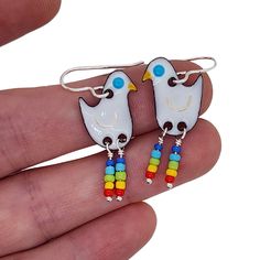 *Colorful and whimsical long legged bird earrings! These are sure to bring a smile to all who see them :) *Choose between white, blue, or red birds.* These earrings are handmade out of glass enamel fused to a copper base. The legs are sterling silver with rainbow color glass beads accenting them (and acting as the leg warmers!). The ear wires are solid sterling silver.*These earrings would make a fun gift to a friend, or gift them to yourself!*I do include rubber stoppers on the back of the ear Whimsical White Hand Painted Earrings, Playful White Nickel-free Earrings, Multicolor Bird Design Earrings As A Gift, Multicolor Bird Design Earrings For Gift, Fun Nickel-free White Earrings, Multicolor Bird Design Earrings Gift, Gift Multicolor Bird Design Earrings, Fun White Nickel-free Earrings, Hand Painted White Fun Jewelry