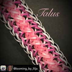 a pink and white braiding on top of a black book with the words talus above it