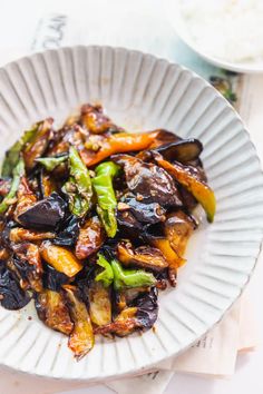 a white plate topped with stir fried vegetables