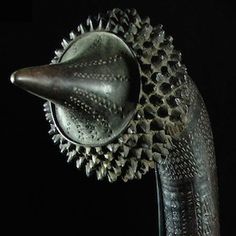 a close up of a metal object with spikes on it's head and neck