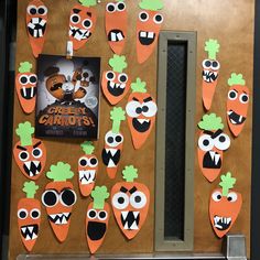 the door is decorated with carrots and faces for halloween decorations, including an advertiser's poster