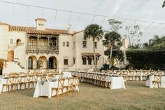 an outdoor dining area with tables and chairs set up in front of a large building