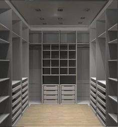 an empty walk in closet with lots of shelves and drawers